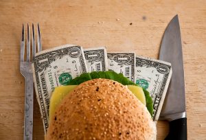 US dollars in a hamburger bun, close-up